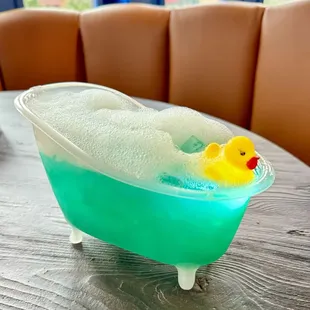 a bath tub with a rubber duck in it