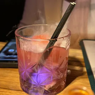 a glass of liquid with a spoon in it