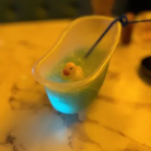 a bowl of liquid with a duck in it