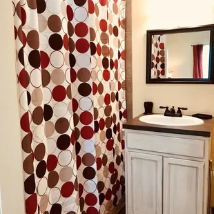 a bathroom with a sink and shower curtain