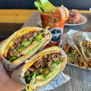 a hand holding a sandwich