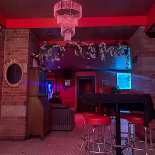 a bar with a chandelier hanging from the ceiling