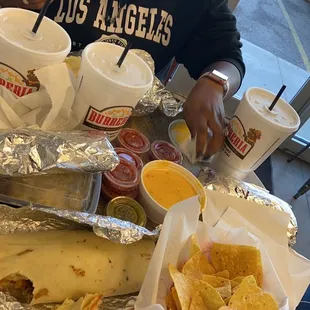 Chile verde bowl with queso asado, chips and cheese dip, chorizo and egg with beans burrito
