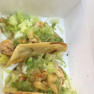 Shrimp and mango crispy tacos with added guacamole