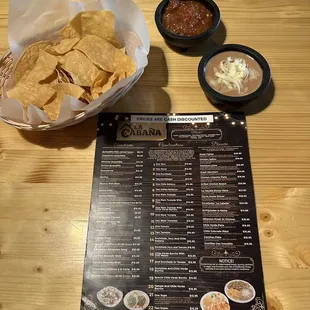 a menu and a bowl of chips