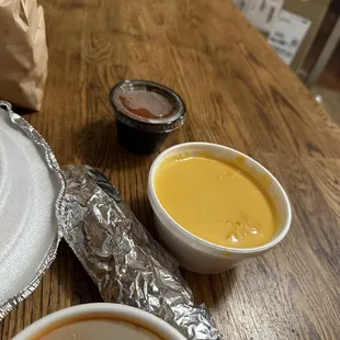 a bowl of soup and a plate of condiments