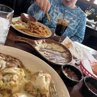 Meals with chips, salsa and queso dip.