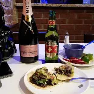 a plate of food and a bottle of champagne