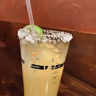 a drink with a lime garnish
