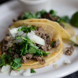 two tacos on a white plate