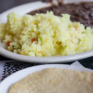 a plate of rice, beans, and a tortilla