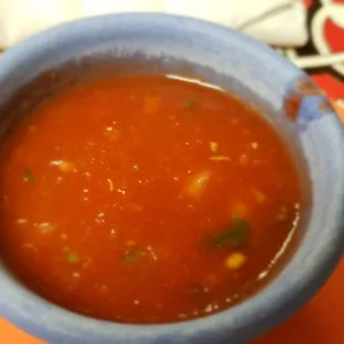 a bowl of salsa on a plate