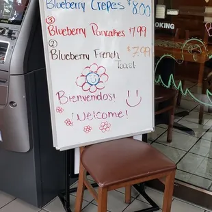 a sign in front of a coffee shop