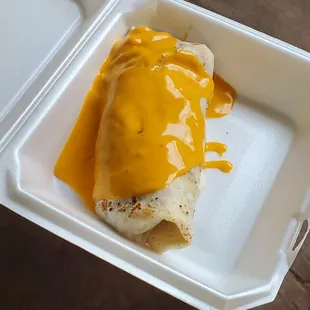 a hot dog covered in cheese