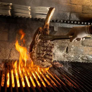 a large piece of meat being cooked on a grill