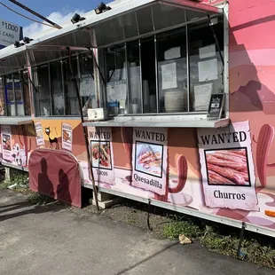 a woman standing in front of a food truck
