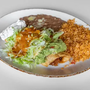 Chimichangas:  Topped with lettuce, sour cream, guacamole, special 
sauce, rice and beans.