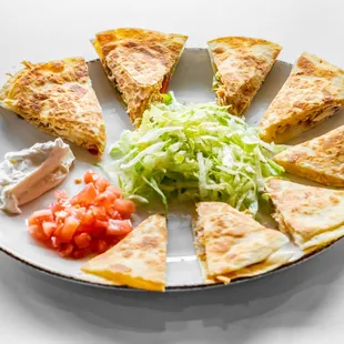 Shredded Cheese Chicken Quesadilla, Triangle flour tortillas stuffed with peppers and onions,  tomatoes and sour cream