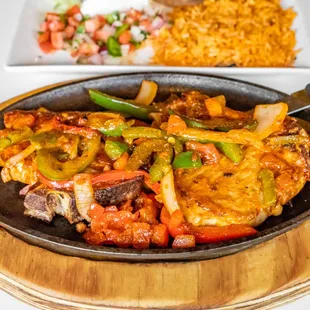 La Calera Pork Chop: American Style lettuce, rice, fries and tomato or  Mexican Style lettuce, pico de gallo refried beans  and guac