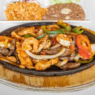 Shrimp Fajitas:  Served with rice, beans, sour cream salad and flour tortillas