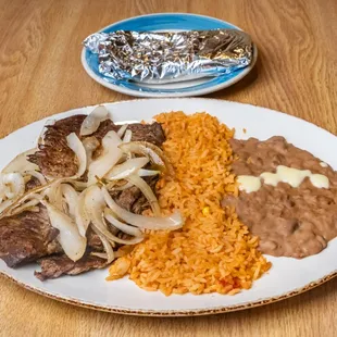 Carne Asada:  Served with rice, beans, onions and tortillas
