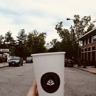 a hand holding a coffee cup