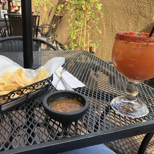 a drink and chips on a table