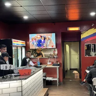 people sitting at tables in a restaurant