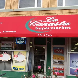 a storefront with a red awning