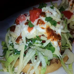 a close up of a sandwich with lettuce and tomatoes