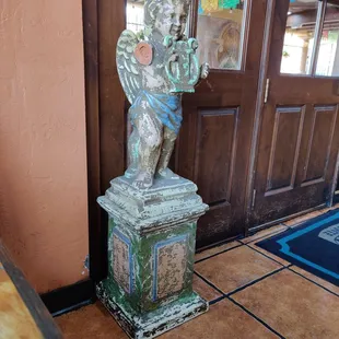 a statue in front of a door