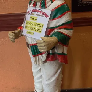 a statue of a man holding a sign