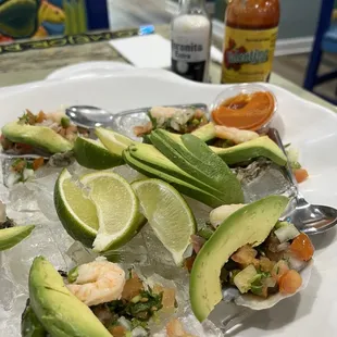 Ostiones al charro negro  6 pieces Oyster with cooked shrimp, tomato, cilantro and avocado