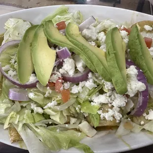 a salad with avocado and feta cheese