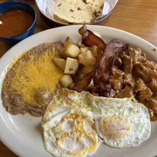 Huevos Rancheros, requested salsa on the side, added side of perfectly prepared Carne Guisada. Requested cheese on beans .