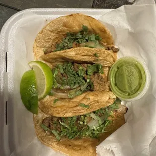 Street tacos with spicy steak and green salsa.  Get these!