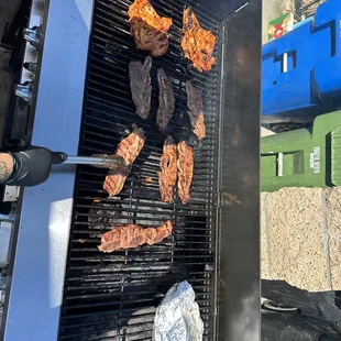 meat being cooked on a grill