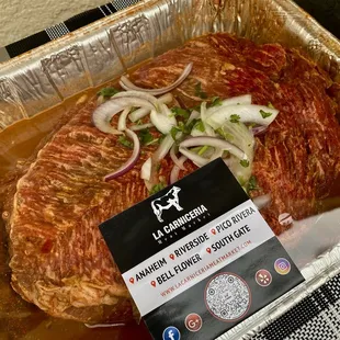 a piece of meat in a foil pan