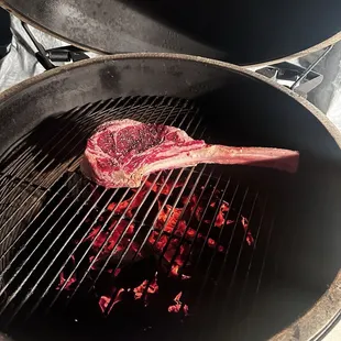 a steak cooking on a grill