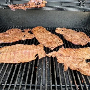 meat being cooked on a grill
