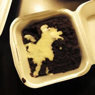a chocolate cake in a styrofoam container