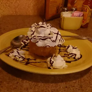 a desert with whipped cream and chocolate sauce