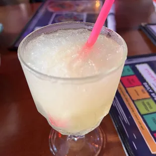 a drink in a glass with a pink straw