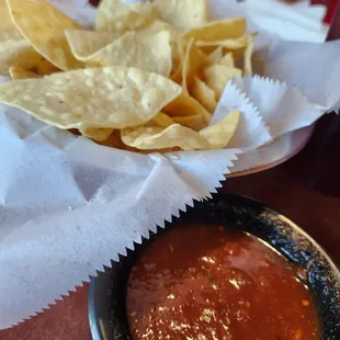 a bowl of salsa and chips