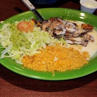 Pollo Cancun.  Grilled Chicken Breast, Grilled Shrimp, Cheese Sauce, Rice And Salad.  Try it!
