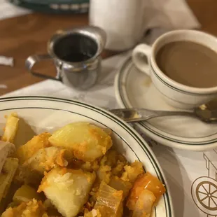 a plate of food and a cup of coffee