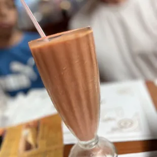 a chocolate milkshake with a straw