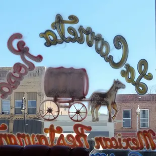 a horse drawn carriage in the window of a mexican restaurant
