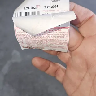 a hand holding a ticket
