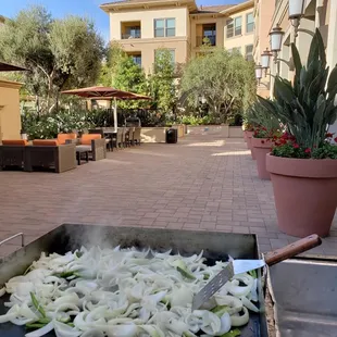 onions being cooked on a grill
